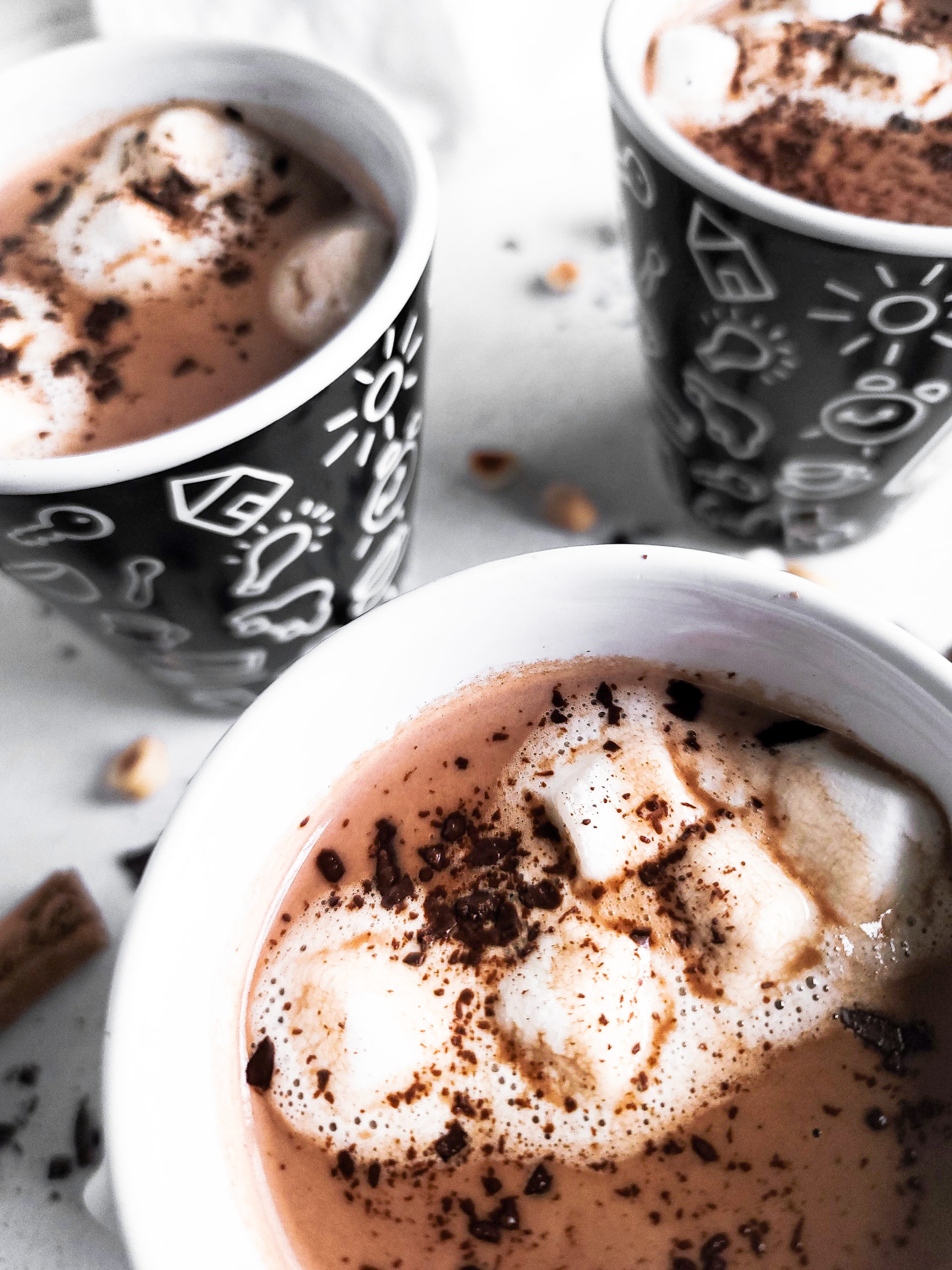 Close up picture of 3 mugs full of hot chocolate